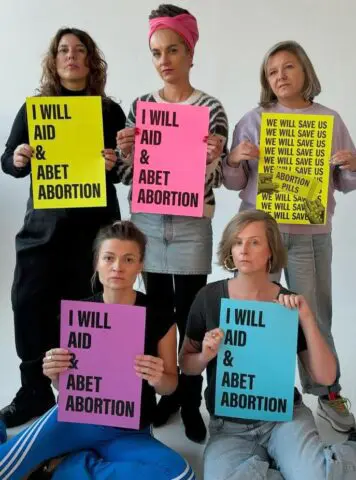 Group of women holding protest signs supporting abortion rights.