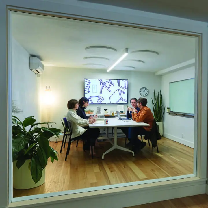 Civilization engaged in a meeting around a conference table in our former office/galler...