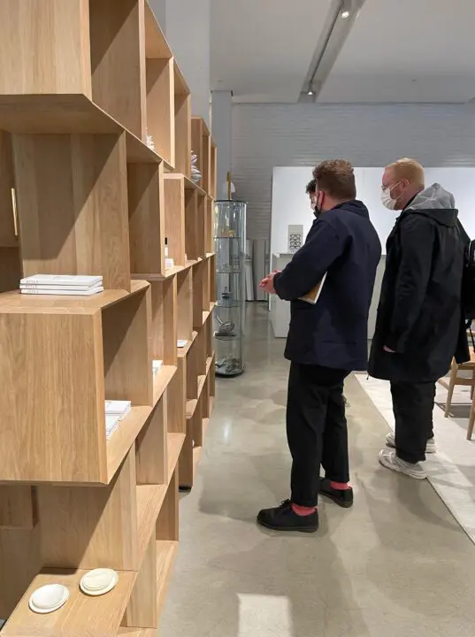 Michael Ellsworth, Corey Gutch, and Randy Bishop browsing the Bocci Series 1 wooden she...