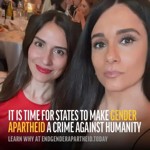 Two women at a formal gathering. Text: It is time for states to make gender apartheid a...