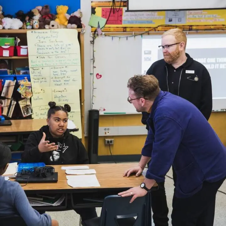 Corey Gutch and Michael Ellsworth engage with students in a lively classroom discussion...