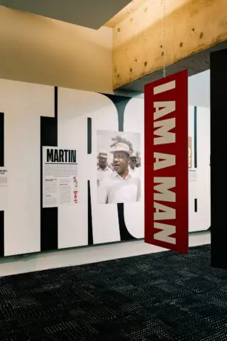 Museum exhibit featuring I AM A MAN sign and a historical photo on civil rights movemen...