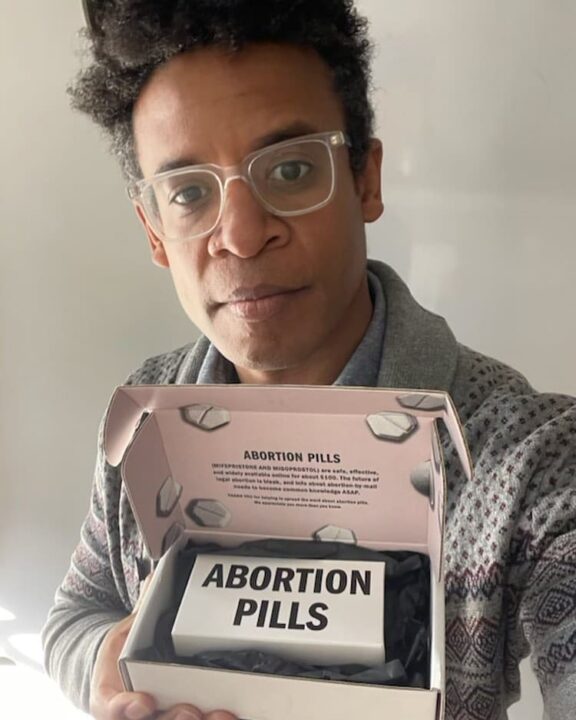 Person holding a box labeled Abortion Pills, providing information about medications co...