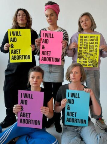 Group of women holding protest signs supporting abortion rights.