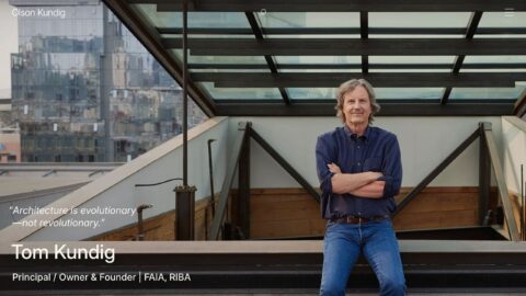 Architect standing on a modern rooftop with city view, emphasizing evolutionary design.