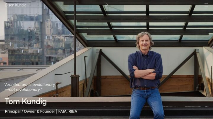 Architect standing on a modern rooftop with city view, emphasizing evolutionary design.