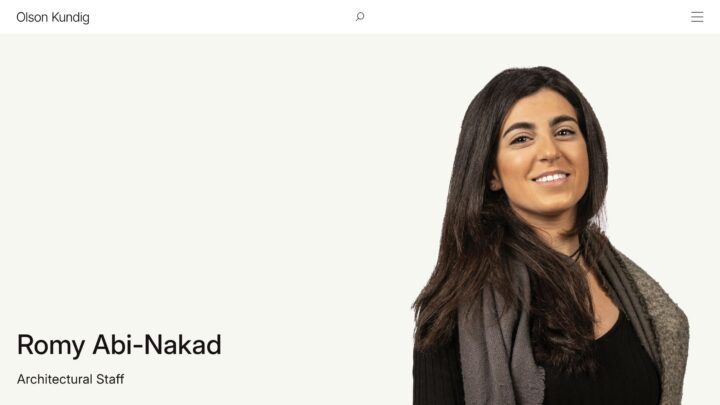 Smiling person with long hair, wearing a scarf, labeled as architectural staff at Olson...