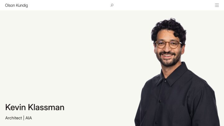 Portrait of a smiling architect in glasses and a black shirt, showcasing his profession...