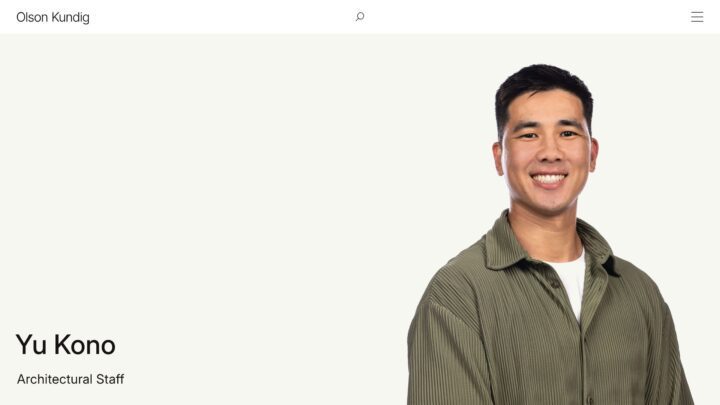 Smiling architectural staff member in a green shirt on a professional profile page.