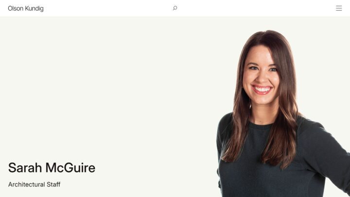 Smiling woman from Olson Kundig architectural staff with long brown hair, wearing a bla...