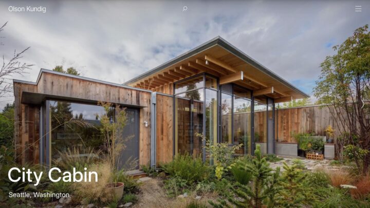 Modern wooden cabin with large glass windows and lush garden, Seattle, Washington. Sust...