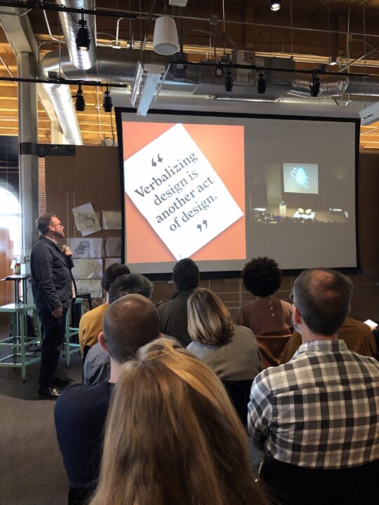 Michael Ellsworth presenting our website design to the Olson Kundig staff at their Seattle office with a slide showing the story of our design studio.