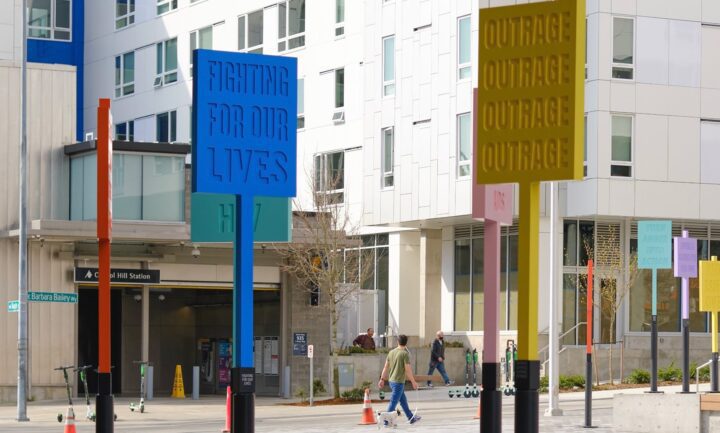 Colorful protest signs with messages like Fighting For Our Lives outside Capitol Hill S...