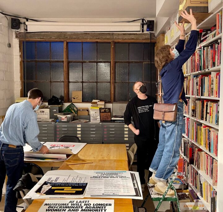 Civilization team looking posters, ephemera and books at the Interference Archive in New York City.