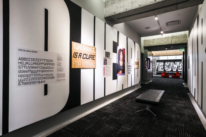 Modern gallery hallway featuring typography art, motivational quotes, and a portrait on...