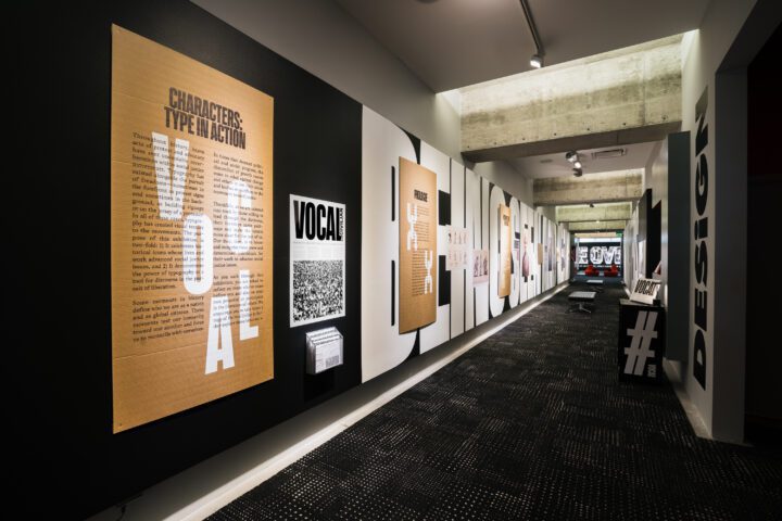 Hallway exhibit featuring typography and graphic design displays on walls, showcasing v...