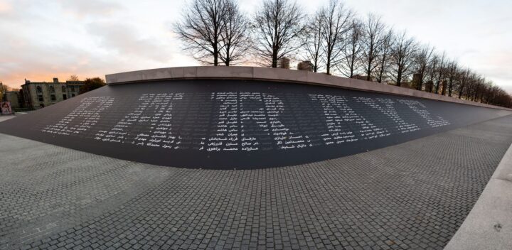 Granite wall at the Irish National Memorial, Dublin with names in Arabic script, framed...
