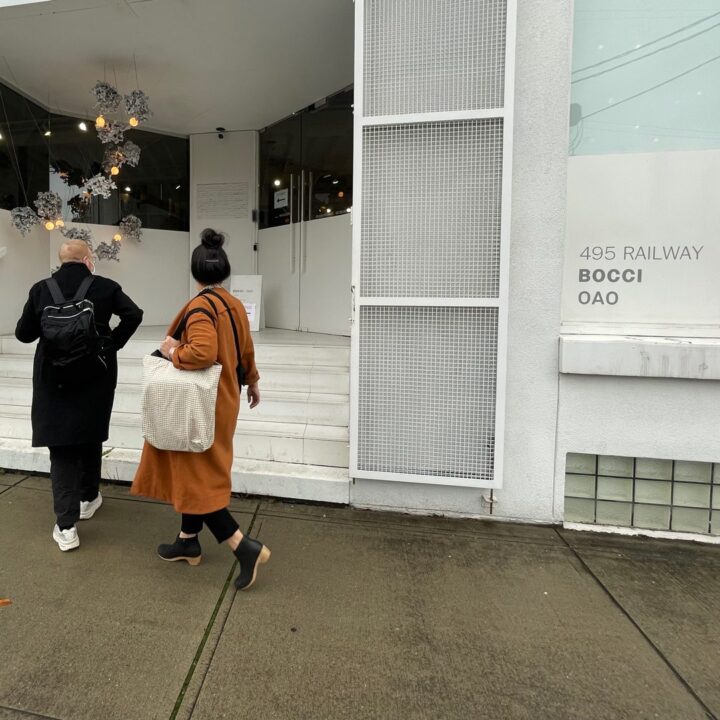 People entering a modern building with the sign 495 Railway Bocci OAO visible, showcasi...