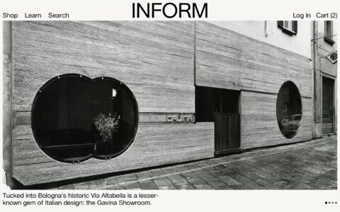 Modern facade of Gavina Showroom on Via Altabella, Bologna, showcasing Italian design with circular windows and textured walls.