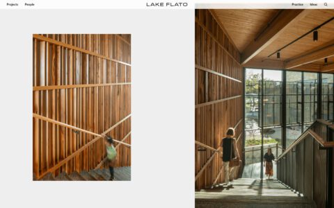 Modern wooden staircase with natural lighting, large windows, and people ascending and descending. Sustainable architectural design.