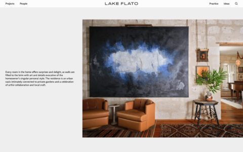 Cozy sitting area with brown chairs, abstract blue and white painting, and rustic decor on a wooden table, enhancing modern interior charm.