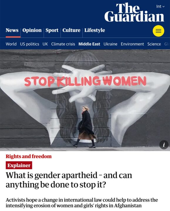 Street art with Stop Killing Women message; woman walks past advocating women’s right...