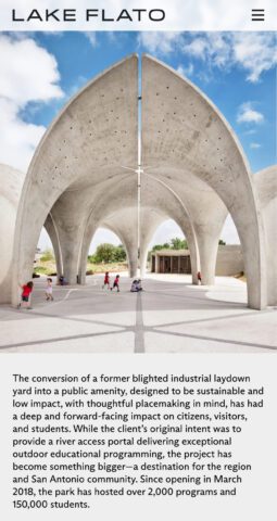 Modern architectural structure with children playing underneath, against a clear blue sky backdrop.