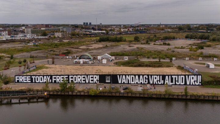 Aerial view of a large mural: Free Today, Free Forever! with surrounding urban and natu...